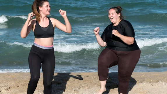 Happy women training together full shot-how much weight can you lose in 4 months