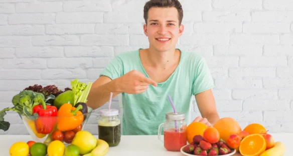 Man pointing finger toward the fresh fruits on the table-healthy energy diet