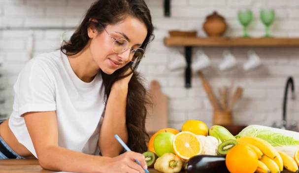 Medium shot girl with glasses writing something-how to lose 30 lbs in 2 months
