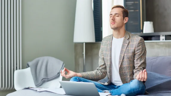 Young freelancer practicing yoga-good daily habits