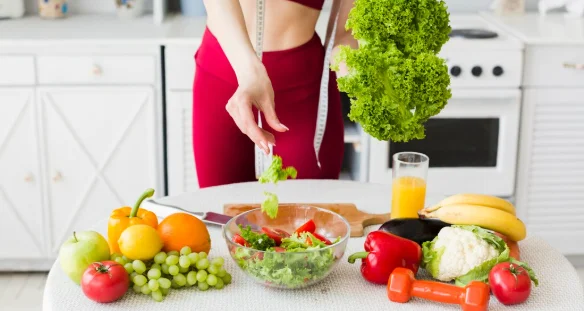 Diet concept with sporty woman in kitchen