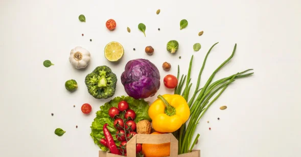 Top view of assortment of vegetables in paper bag