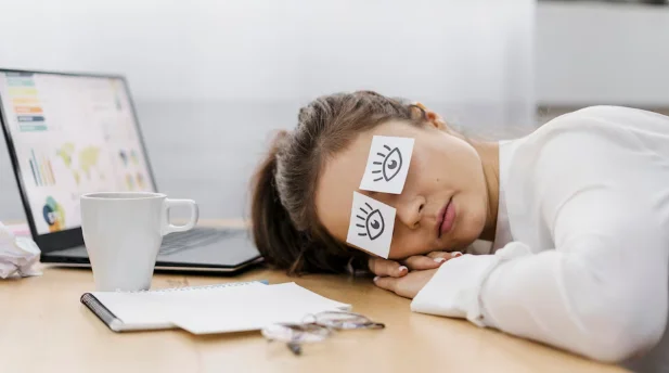 Tired businesswoman covering her eyes with drawn eyes on paper-how much body fat can you lose in a month