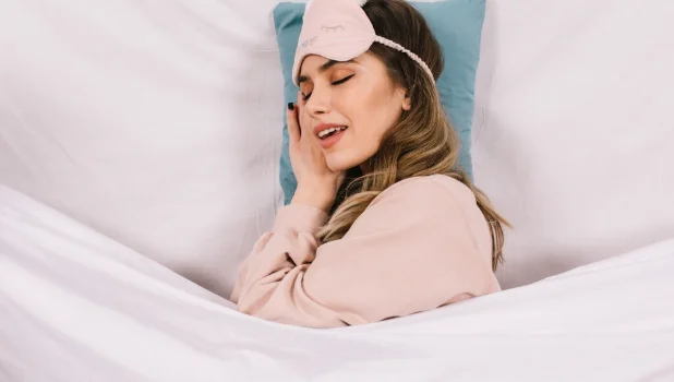 Debonair young woman sleeping in bed-how long to lose 30 lbs