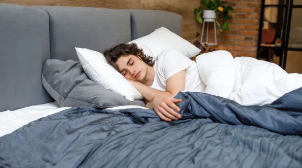 Man sleeping in bed with soft daylight-what does it mean to be healthy