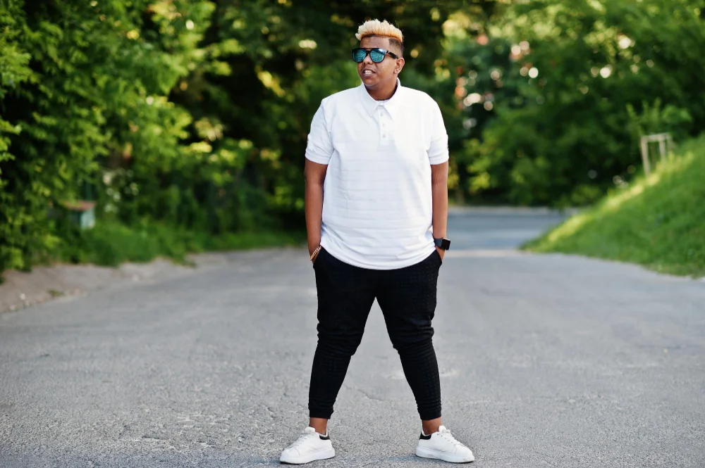 Casual outfit idea for men with dark jeans and a white T-shirt styled with sneakers.