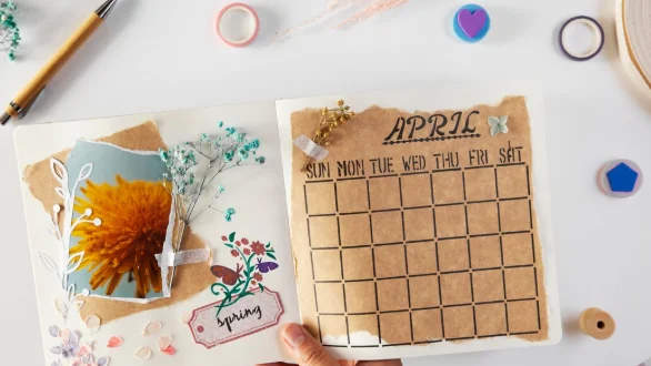 Top view hand holding scrapbook with flowers-diy for decorating room