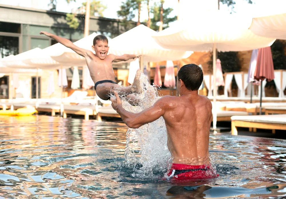 Family enjoying a hotel pool with children
