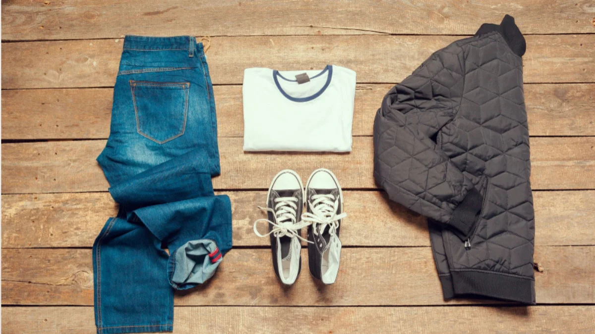 Flat lay of men’s fashion outfits from different styles arranged together.