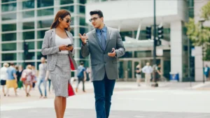 Stylish casual blazer outfits for men and women walking in the city.