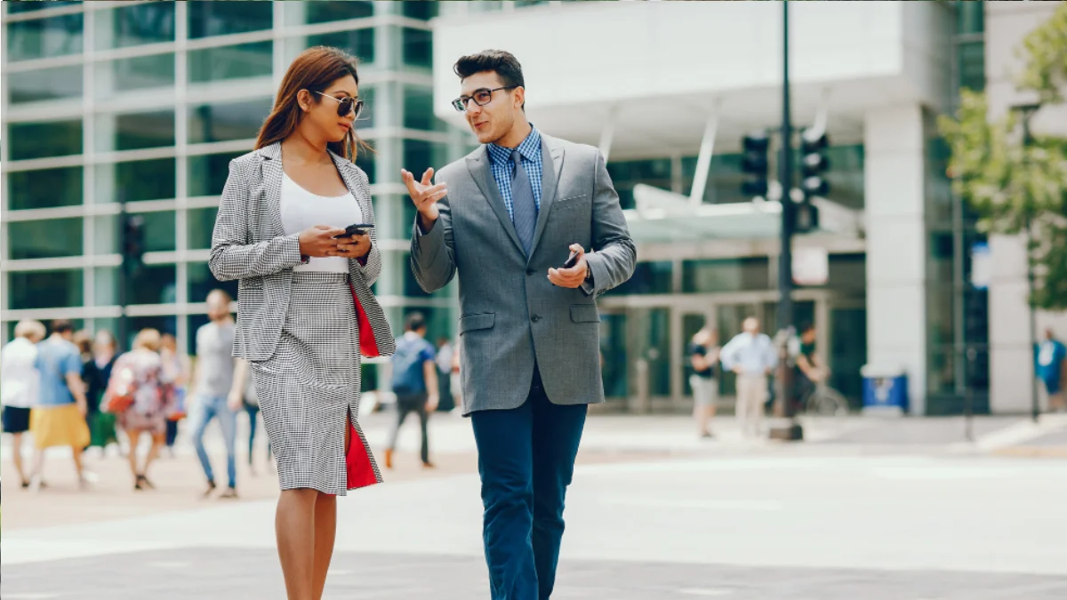 Stylish casual blazer outfits for men and women walking in the city.