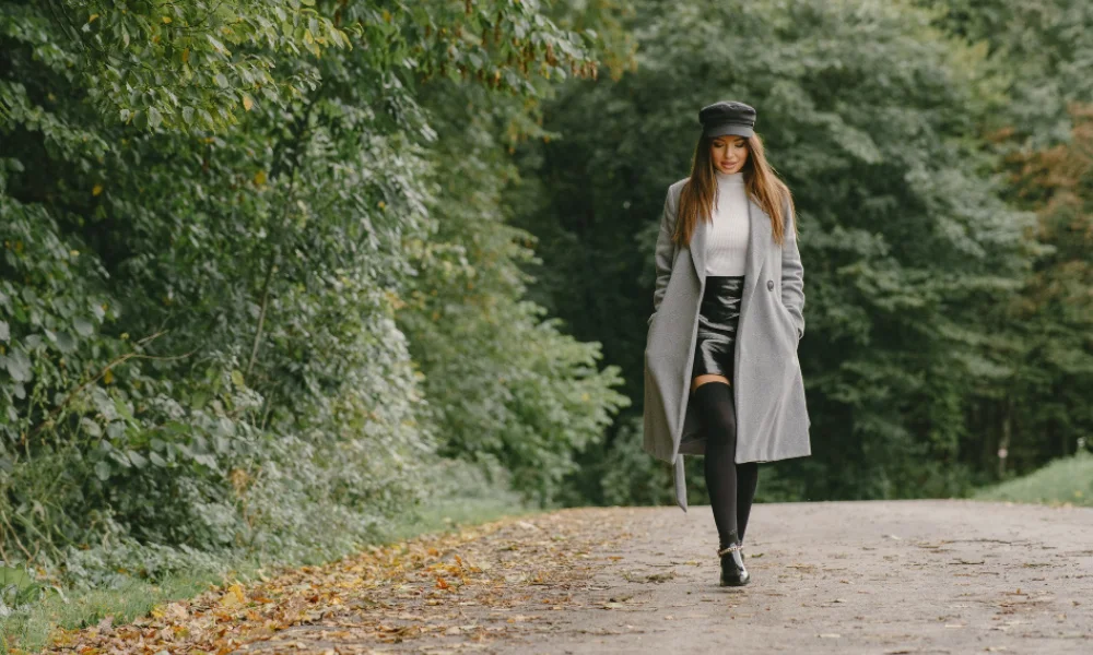 Stylish woman walking outdoors wearing trendy fall 2025 outfit.