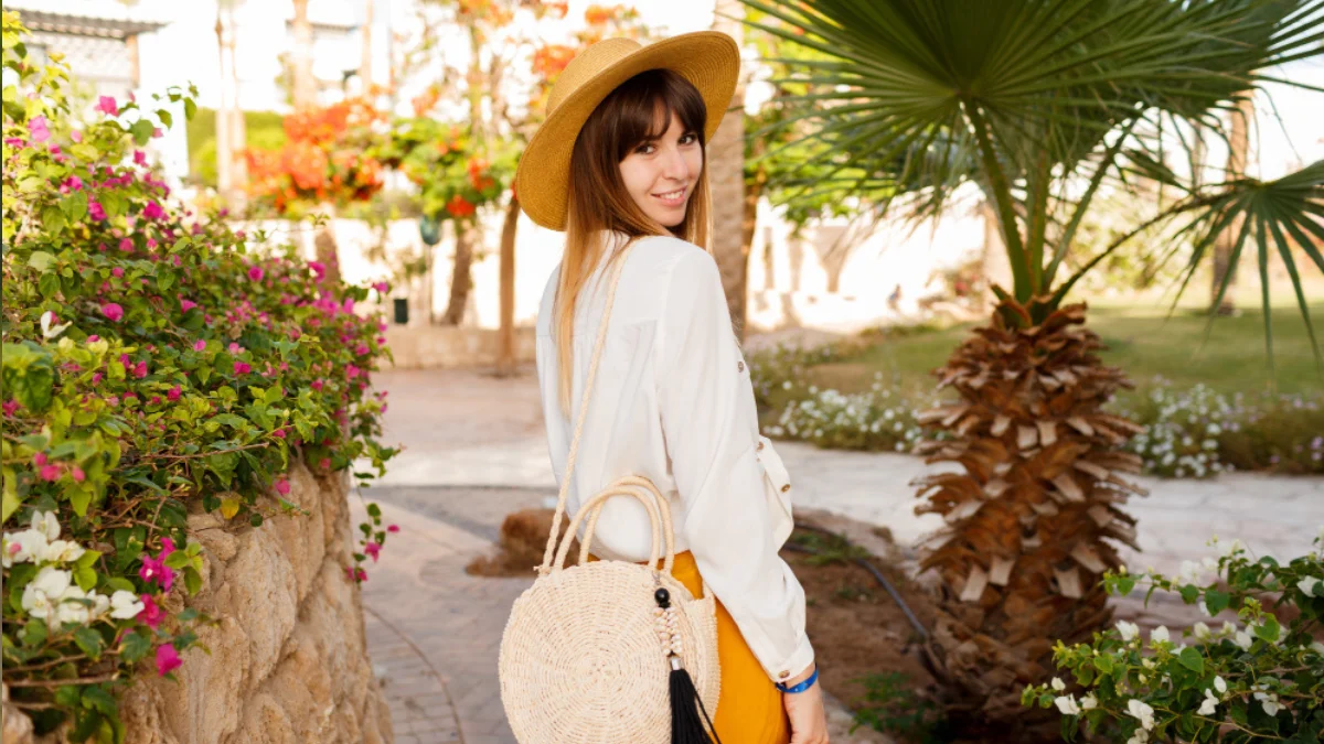 Woman in summer casual outfit with cotton dress, sun hat,