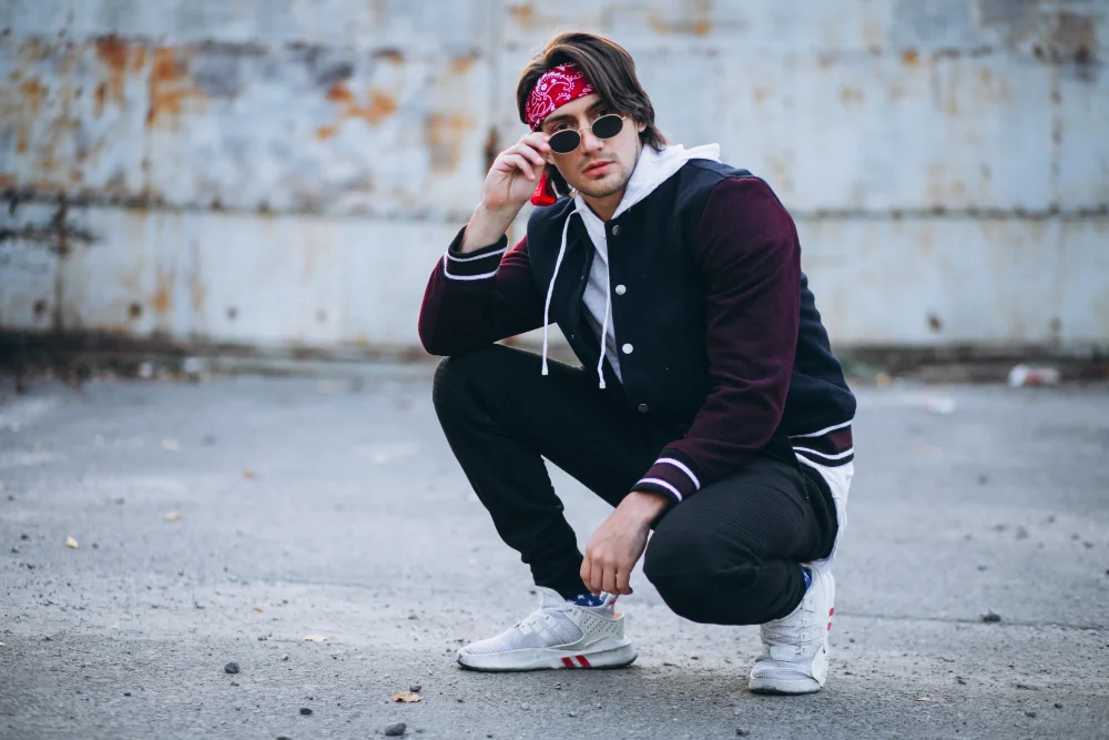 Young man in oversized hoodie, graphic tee, and sneakers