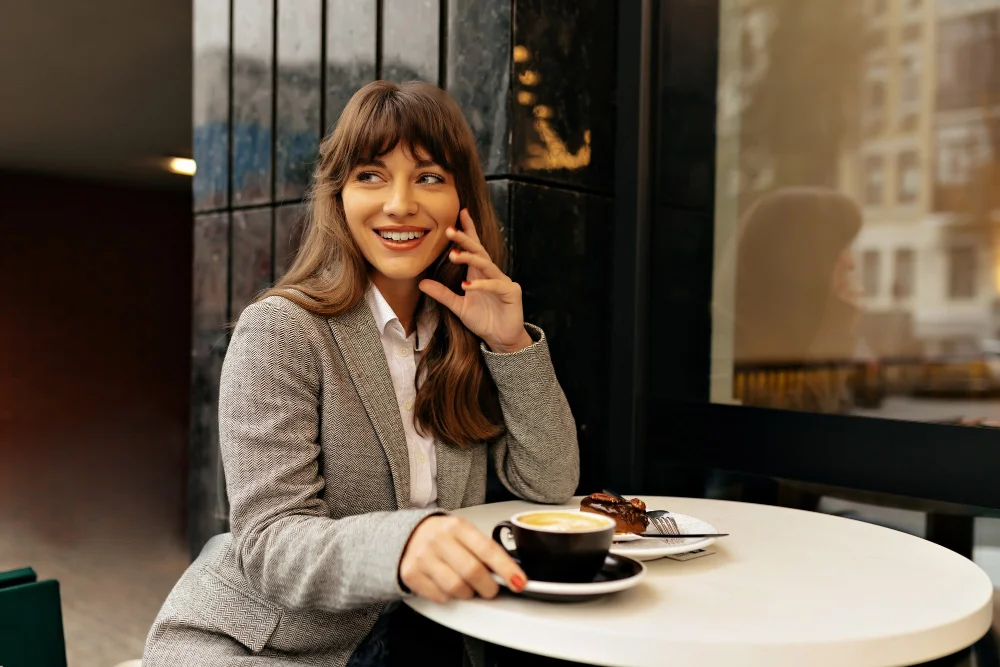 woman at a café in a beige blazer